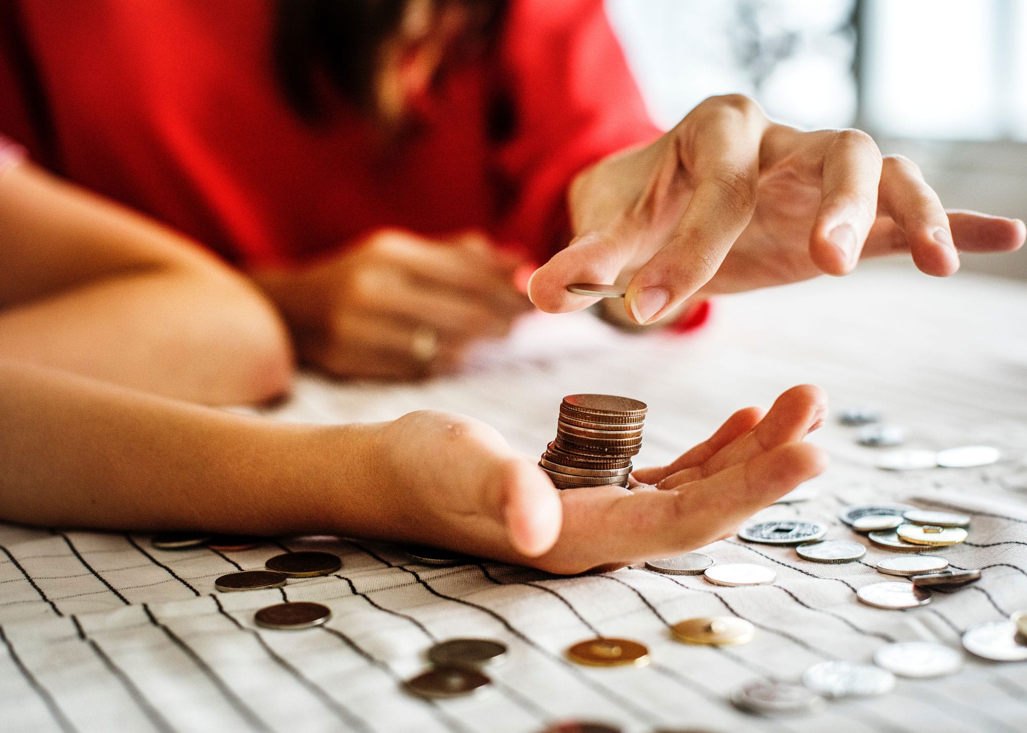 Why is my tax refund so small this year? | A lady stacking pennies within another person's hand