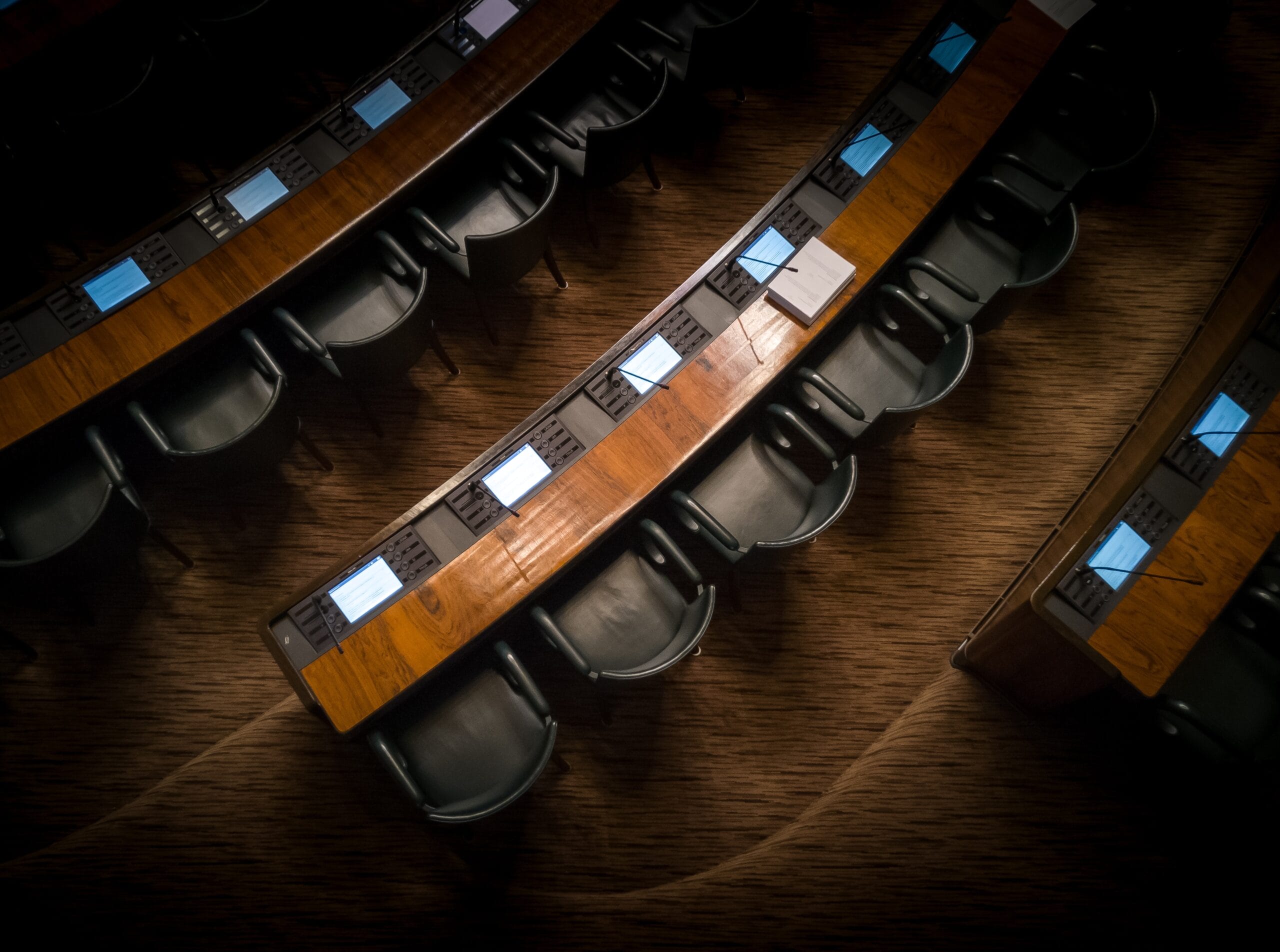 Empty lecture hall with a top view of the chairs, desks, and monitors