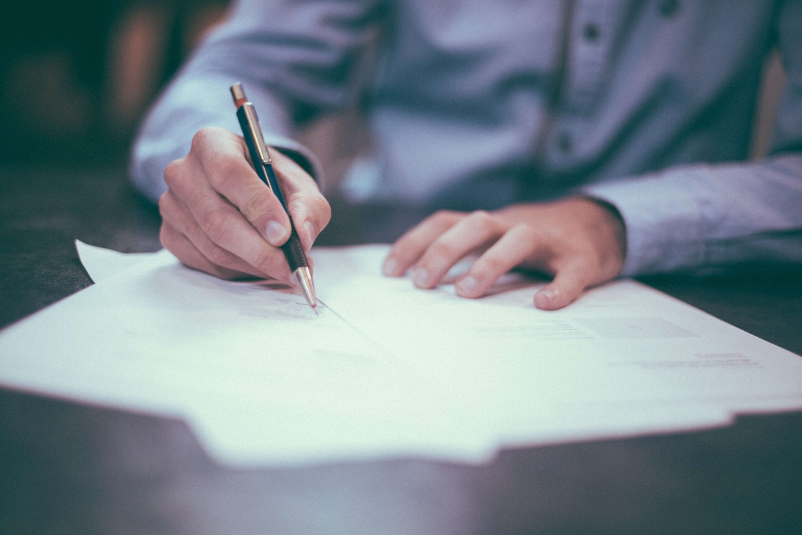 A man signing documents